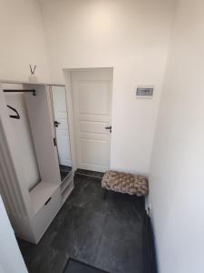 a walk in closet with a bench and a mirror at UrbanHome1 in Rokiškis