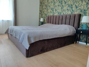 a large bed in a bedroom with at UrbanHome1 in Rokiškis