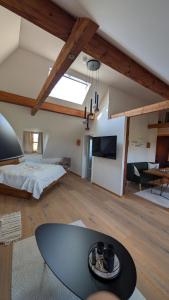 a room with a bed and a table in a room at Das Fichtelgut in Wunsiedel