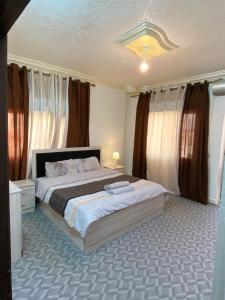 a bedroom with a large bed with curtains at بوابة جرش Jarash Gate in Jerash