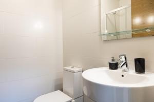 a white bathroom with a sink and a toilet at Loft 2 by Basquelidays in Hondarribia +20 photos