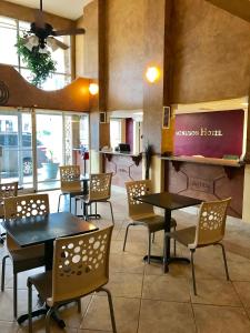 a restaurant with tables and chairs in a room at Coachman's Inn in Magnolia