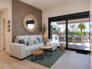 a living room with a couch and a table at Hillside Luxury Villas by NRAS in Finestrat