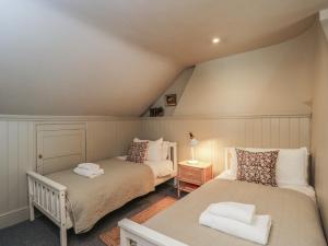 a attic bedroom with two beds and a lamp at Cotswold House in Moreton in Marsh