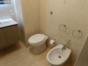 a small bathroom with a toilet and a sink at Aura in Scilla +16 photos