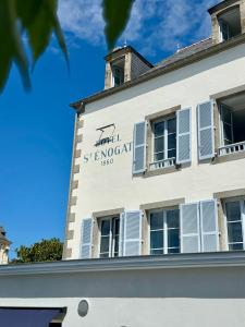 a building with a sign on the side of it at Hotel Saint-Enogat in Dinard