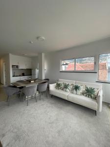 a living room with a couch and a table at Esmeralda Holidays Apartments in Funchal
