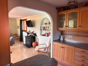 a kitchen with an archway leading to a living room at Casa Peregil in Perelló