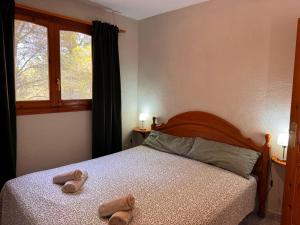 a bedroom with a bed with two slippers on it at Casa Peregil in Perelló +29 photos