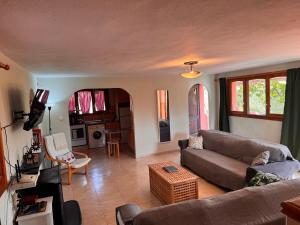 a living room with a couch and a table at Casa Peregil in Perelló