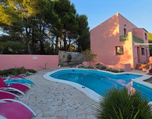 a swimming pool in front of a house at Casa Peregil in Perelló