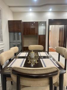 a dining room with a table and chairs at Premium 2 bed room apartment in Lahore