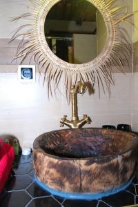 a bathroom sink with a large mirror above it at Eco Lodge ZEN GARDEN in Paul