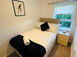 a small bedroom with a bed and a window at Balne Mill Grove in Wakefield
