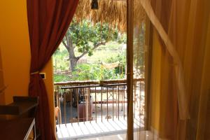 an open window with a view of a yard at Eco Lodge ZEN GARDEN in Paul