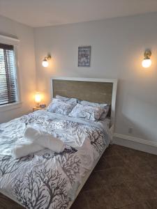 a bed in a bedroom with two pillows on it at Charming Condo - Pool, Minutes to Beach in Pompano Beach