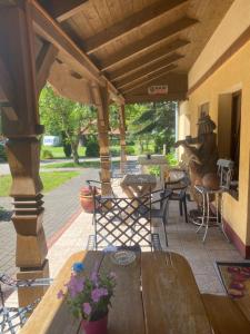 a patio with a wooden pergola and a table at Agroturystyka Pod Podkową in Mrągowo