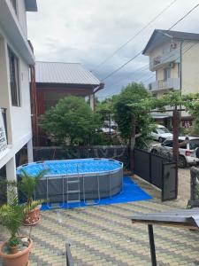 a large swimming pool in a yard with a building at LouNik stay hotel and rooms in Kobuleti