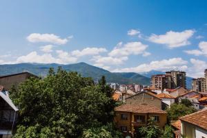 a city with buildings and mountains in the background at Artelo - Inspired Stay in Bitola