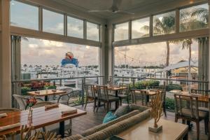 a restaurant with tables and chairs and a view of a marina at Hilton Key West Resort & Marina in Key West