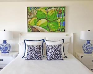 a bedroom with a bed with two blue and white pillows at Hilton Key West Resort & Marina in Key West +46 photos