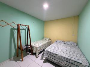 a bedroom with a bed and a mirror at Quarto Boto Tucuxi in Santarém