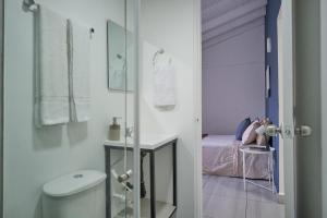 a bathroom with a sink and a toilet and a bed at Poblado-Aguacatala Apart-Hotel in Envigado +194 photos