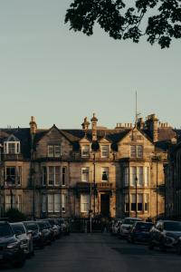 a large building with cars parked in front of it at The Kithmore in St. Andrews