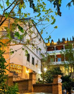a hotel with a sign on the side of a building at Hotel Kalanga in Tbilisi City