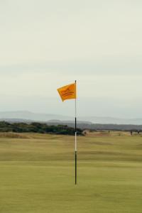 a yellow flag on a golf course at The Kithmore in St. Andrews