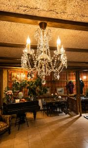 a chandelier in a room with a table and chairs at Hotel Kalanga in Tbilisi City