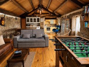 a living room with a couch and a pool table at New Riyork Sweet Home in Geres