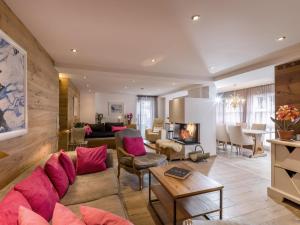 a living room with a couch and a fireplace at Premium Mountain View Suite in Kirchberg in Tirol