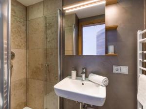 a bathroom with a sink and a shower at Premium Mountain View Suite in Kirchberg in Tirol +6 photos