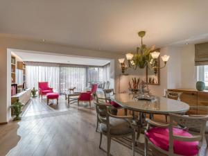 a dining room and living room with a table and chairs at Garten Suite mit 2 separaten Studios in Kirchberg in Tirol