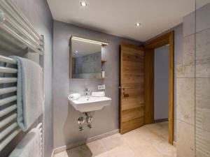a bathroom with a sink and a mirror at Garten Suite mit 2 separaten Studios in Kirchberg in Tirol