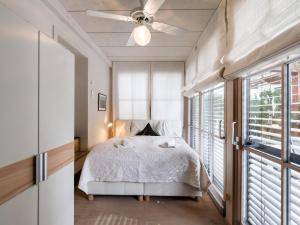 a bedroom with a bed and a ceiling fan at Exclusive Garden Suite in Kirchberg in Tirol