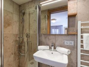 a bathroom with a sink and a shower at Exclusive Garden Suite in Kirchberg in Tirol