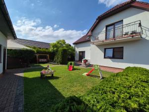 a yard with a playground in front of a house at Malinowe Lato in Grzybowo