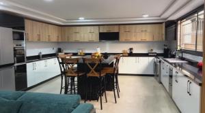 a kitchen with white cabinets and a table and chairs at YourHome in Casablanca