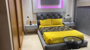 a bedroom with a bed with a yellow bedspread at YourHome in Casablanca
