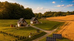 an aerial view of two houses in a field with solar panels at W Sercu Kotliny - luksusowe wille z prywatnymi saunami, baliami i widokiem na góry in Kłodzko