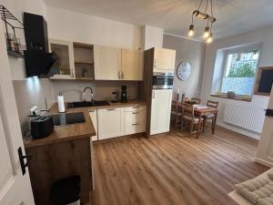 a kitchen with white cabinets and a table in it at Alte Schmiede Karden in Treis-Karden