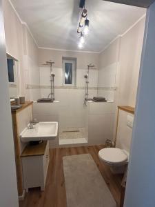 a bathroom with a sink and a toilet at Alte Schmiede Karden in Treis-Karden +8 photos