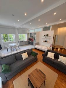 a living room with a couch and a table at Bavaria Home Modern Living in Geisenfeld