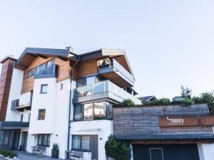 a large white building with a balcony on top of it at Studio mit Lounge in Kirchberg in Tirol