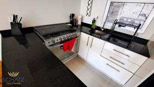 a kitchen with a stove and a sink at QBICo Santa Fe Condominium in Mexico City