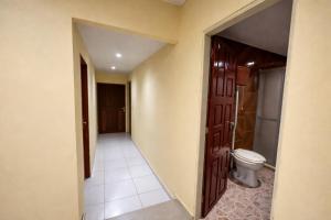 an empty bathroom with a toilet and a door at Quarto Sairé in Santarém +40 photos