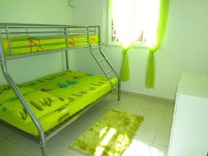 a bedroom with a bunk bed with a yellow mattress at Villa Palulie in Capesterre-Belle-Eau