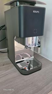a krups espresso machine sitting on a table at Maisonnette à Montélimar in Montélimar